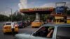 FILE: Drivers wait their turn to fuel their vehicles at a gas station in Havana, Cuba, July 14, 2022 