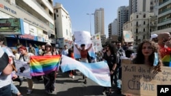 FILE - Activists from the Lesbian, Gay, Bisexual, and Transgender (LGBTQ) community in Lebanon shout slogans calling on the government for more rights, in Beirut, June 27, 2020.