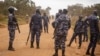 FILE - Police officers secure an area in Kayunga, Uganda, Dec. 14, 2021. Uganda on Monday deployed a police force to its border with the Democratic Republic of Congo after a deadly shooting there involving U.N. peacekeeping troops.
