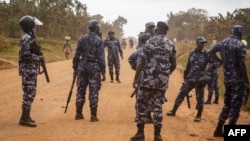 FILE - Police officers secure an area in Kayunga, Uganda, Dec. 14, 2021. Uganda on Monday deployed a police force to its border with the Democratic Republic of Congo after a deadly shooting there involving U.N. peacekeeping troops.