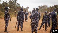 FILE - Police officers secure an area in Uganda on Dec. 14, 2021. Ugandan security forces arrested six people accused of building improvised explosive devices, in a raid in the Central Wakiso district from May 7 to 8, 2023.