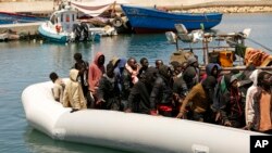  FILE - Migrants heading to Europe are brought back to port after being intercepted in the Mediterranean Sea by the Libyan coast guard, in Gasr Garabulli, northwestern Libya, May 23 2022. 