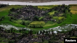 FILE - The remains of a burned Rohingya village are seen in this aerial photograph near Maungdaw, north of Rakhine State, Myanmar Sept. 27, 2017.