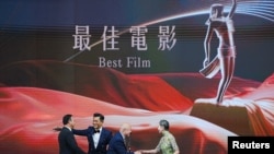 Actor Louis Koo presents the Best Film award to representatives of "Raging Fire" at the 40th Hong Kong Film Awards in Hong Kong, July 17, 2022. 