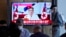 People watch TV news showing an image of North Korea leader Kim Jong Un, at the Seoul Railway Station in Seoul, South Korea, July 28, 2022. Kim warned he's ready to use his nuclear weapons in potential conflicts with the United States and South Korea, state media said.