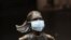 A surgical mask is placed on the "Fearless Girl" statue outside the New York Stock Exchange in New York, March 19, 2020.