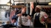 U.S. Secretary of State Antony Blinken, left, speaks with jeans designer Tshepo as he tours the Victoria Yards neighborhood in Johannesburg, on August 7, 2022.