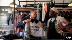 U.S. Secretary of State Antony Blinken, left, speaks with jeans designer Tshepo as he tours the Victoria Yards neighborhood in Johannesburg, on August 7, 2022.