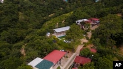 Police conduct a raid against alleged migrant smugglers near the Mexican border in Huehuetenango, Guatemala, Aug. 2, 2022. Authorities found horse stables, a swimming pool, late-model vehicles, and guns at the ranch.