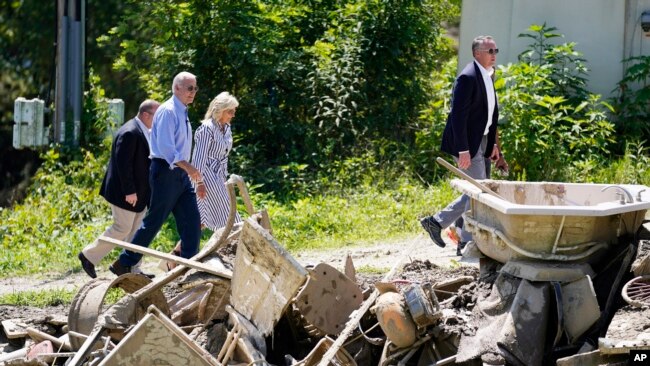 President Joe Biden and first lady Jill Biden tour a neighborhood impacted by flooding, Aug. 8, 2022, in Lost Creek, Kentucky.