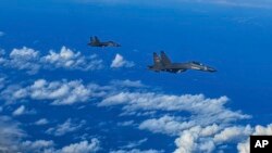 In this photo released by Xinhua News Agency, fighter jets of the Eastern Theater Command of the Chinese People's Liberation Army conduct a joint combat training exercises around the Taiwan Island, Aug. 7, 2022. (Gong Yulong/Xinhua via AP)