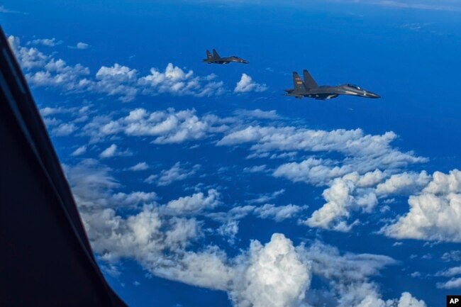 In this photo released by Xinhua News Agency, fighter jets of the Eastern Theater Command of the Chinese People's Liberation Army conduct a joint combat training exercises around the Taiwan Island, Aug. 7, 2022. (Gong Yulong/Xinhua via AP)