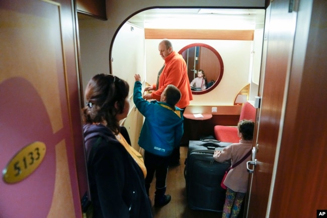 Ukrainian refugees enter their cabin after arriving on the ferry Isabelle in Tallinn, Estonia, Wednesday, June 15, 2022. Around 2,000 refugees from Ukraine live on the ferry. (AP Photo)