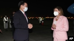 In this photo released by the Taiwan Ministry of Foreign Affairs, U.S. House Speaker Nancy Pelosi, right, is greeted by Taiwan's Foreign Minister Joseph Wu as she arrives in Taipei, Taiwan, Aug. 2, 2022. (Taiwan Ministry of Foreign Affairs via AP)