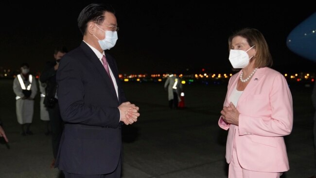 In this photo released by the Taiwan Ministry of Foreign Affairs, U.S. House Speaker Nancy Pelosi, right, is greeted by Taiwan's Foreign Minister Joseph Wu as she arrives in Taipei, Taiwan, Aug. 2, 2022. (Taiwan Ministry of Foreign Affairs via AP)