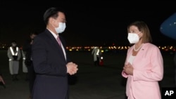 FILE - In this photo released by the Taiwan Ministry of Foreign Affairs, U.S. House Speaker Nancy Pelosi, right, is greeted by Taiwan's Foreign Minister Joseph Wu as she arrives in Taipei, Taiwan, Aug. 2, 2022.