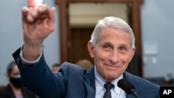 FILE - Dr. Anthony Fauci, Director of the National Institute of Allergy and Infectious Diseases, waves to a House committee at the start of a hearing on Capitol Hill in Washington on May 11, 2022. 