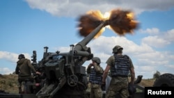 Ukrainian service members fire a shell from a towed howitzer FH-70 at a front line, as Russia's attack on Ukraine continues, in Donbas Region, Ukraine, July 18, 2022. 