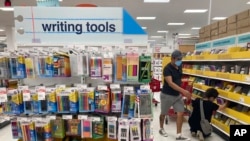 FILE - Shoppers look for school supplies deals at a Target store, Wednesday, July 27, 2022, in South Miami, Fla.