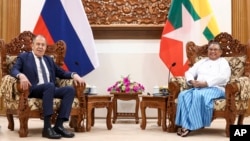 In this handout photo released by the Russian Foreign Ministry Press Service, Myanmar Foreign Minister Wunna Maung Lwin, right, and Russian Foreign Minister Sergey Lavrov pose for a photo prior to their talks in Naypyitaw, Myanmar, Wednesday, Aug. 3, 2022