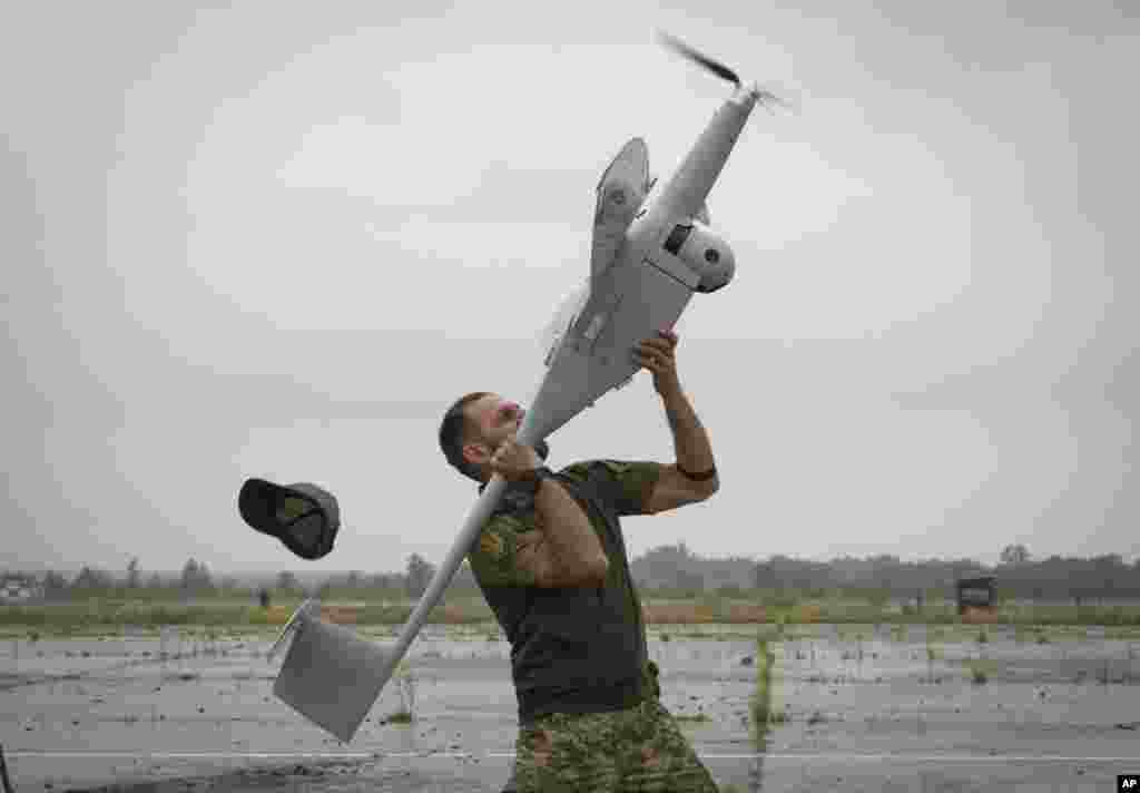 A Ukrainian soldier launches FlyEye WB Electronics SA, a Polish reconnaissance drone in Kyiv region, Aug. 2, 2022.