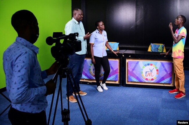 Professional sign Language interpreter Jonan Opori, Productions Lead at Signs TV Uganda Susan Mujaawa and Signs TV Uganda Team Leader Simon Eroku are filmed inside their studio in Kabalagala suburb of Kampala, Uganda July 18, 2022.