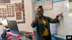 FILE - Josephine Alade teaches math to 9th and 10th graders at Roosevelt High School - Early College Studies, Thursday, Oct. 15, 2020, in Yonkers, N.Y. (AP Photo/Mary Altaffer)