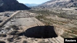 A sinkhole that emerged last week has doubled in size, at a mining zone close to Tierra Amarilla town, in Copiapo, Chile, Aug. 7, 2022.