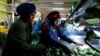 FILE - Workers sort avocados at the Mofarm fresh fruits exporters factory in Utawala area in the outskirts of Nairobi, Kenya March 17, 2022.