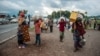 FILE - Internally displaced people from the Kibumba area near the North Kivu city of Goma, arrive on May 25, 2022 at the Kunyaruchinya school trying to shelter from the ongoing clashes between the Congolese Army and the M23 rebels.