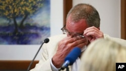 Neil Heslin, father of 6-year-old Sandy Hook shooting victim Jesse Lewis, becomes emotional during his testimony during the trial for Alex Jones, Aug. 2, 2022, at the Travis County Courthouse in Austin.