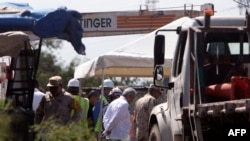 Mexican President Andres Manuel Lopez Obrador (C) visits the flooded coal mine where 10 miners have been trapped since Wednesday after a collapse, in the community of Agujita, Sabinas Municipality, Coahuila State, Mexico, on August 7, 2022.