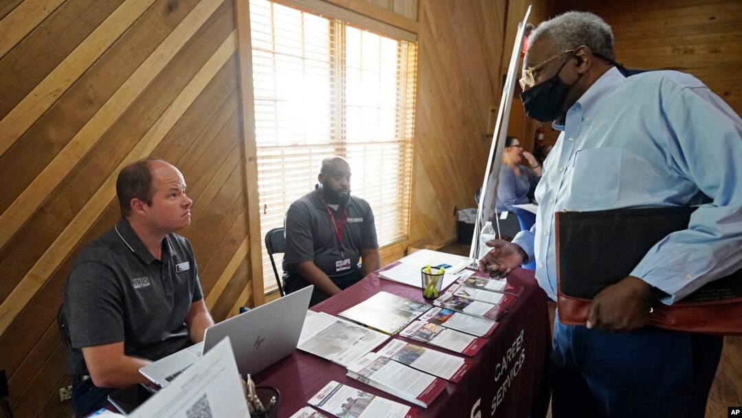 Robert Allen, director of work based learning, left, and Rod Mallett, work based learning coordinator, center, at Hinds Community College (AP Photo/Rogelio V. Solis)