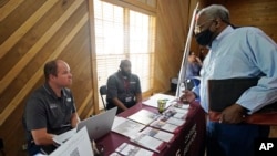 Robert Allen, director of work based learning, left, and Rod Mallett, work based learning coordinator, center, at Hinds Community College (AP Photo/Rogelio V. Solis)