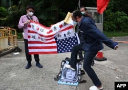 A pro-Beijing protester stamps on an image depicting U.S. House Speaker Nancy Pelosi at a protest outside the U.S. Consulate in Hong Kong on August 3, 2022, after Pelosi arrived in Taiwan as part of a tour of Asia.