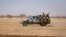 FILE: Burkina Faso soldiers patrol aboard a pick-up truck on the road from Dori to the Goudebo refugee camp. Taken 2.3.2020