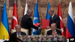 Turkish President Recep Tayyip Erdogan, right, and U.N. Secretary General Antonio Guterres lead a signing ceremony at Dolmabahce Palace in Istanbul, Turkey, Friday, July 22, 2022.