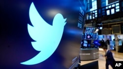 The logo for Twitter appears above a trading post on the floor of the New York Stock Exchange in this Nov. 29, 2021, file photo. 