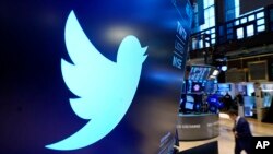 FILE: The logo for Twitter appears above a trading post on the floor of the New York Stock Exchange. Taken 11.29.2021