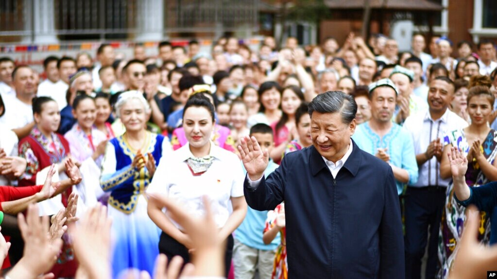 In this photo released by China's Xinhua News Agency, Chinese President Xi Jinping, center, visits the community of Guyuanxiang in the Tianshan District in Urumqi in northwestern China's Xinjiang Uyghur Autonomous Region, July 13, 2022. 