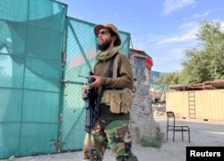 A Taliban fighter stands guard near the site where al-Qaida leader Ayman al-Zawahiri was killed in a U.S. strike over the weekend, in Kabul, Afghanistan, Aug. 2, 2022.