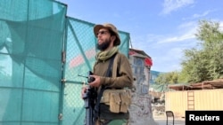FILE - A Taliban fighter stands guard near the site where al-Qaida leader Ayman al-Zawahiri was killed in a U.S. strike over the weekend, in Kabul, Afghanistan, Aug. 2, 2022. The Taliban have ordered journalists not to go near the area.