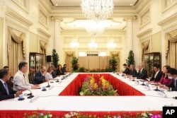 In this photo provided by Ministry of Communications and Information, Singapore, U.S. House Speaker Nancy Pelosi, fourth from left, and Prime Minister Lee Hsien Loong, fourth from right, meet at the Istana Presidential Palace in Singapore, Monday, Aug. 1,