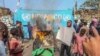 A resident holds a placard reading ''MONUSCO get out without delay'' during protests against the United Nations peacekeeping force (MONUSCO) deployed in the Democratic Republic of the Congo, in Goma, July 25, 2022.