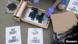 FILE - An activist makes signs during a protest outside the U.S. Supreme Court on May 3, 2022 preparing for the overturn of Roe v. Wade abortion rights decision. (REUTERS/Elizabeth Frantz)