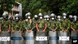 Police commandos stand guard at a barricade outside president's office in Colombo, Sri Lanka, July 22, 2022.