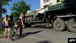 Russian military vehicles move through the city of Mariupol on July 15, 2022, amid the ongoing Russian military action in Ukraine. 