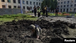 A sapper works at a compound of the National Academy of Urban Economy damaged by a Russian military strike, as Russia's attack on Ukraine continues, in Kharkiv, Ukraine July 23, 2022. 