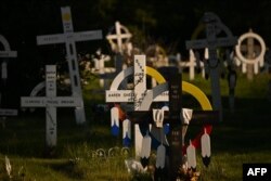 This photograph taken on July 23, 2022, shows crosses marking graves at the Ermineskin Cemetery near the site of the Ermineskin Residential School in Maskwacis, Alberta, July 23, 2022, ahead of Pope Francis' visit to Canada.