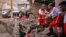 A handout picture provided by the Iranian Red Crescent shows members of a rescue team working at the site of a flash flood in Imamzadeh Davood, northwest of Tehran, July 29, 2022.